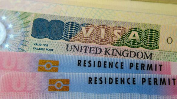 Immigration challenges: A close up of a UK visa and residence permit.