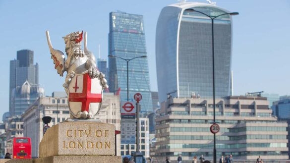 City of London statue with several London high-rise buildings in the background