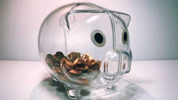 Glass piggy bank with copper coins inside