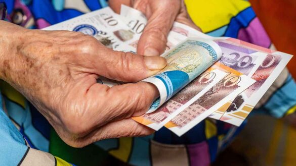 Pension adequacy: photo shows elderly hands handling cash.