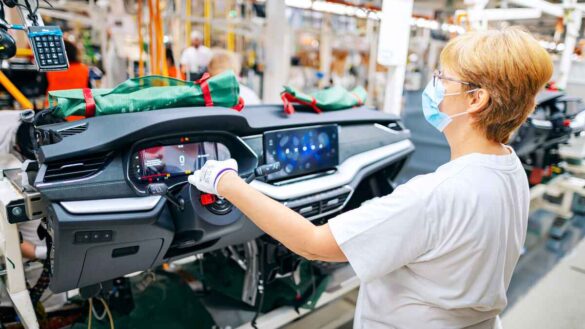 VW job cuts. Photo shows a Volkswagen worker in a factory.