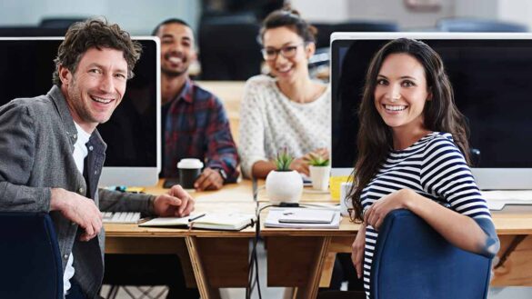 Redefining employee relations webinar. Image shows a happy team in an office.